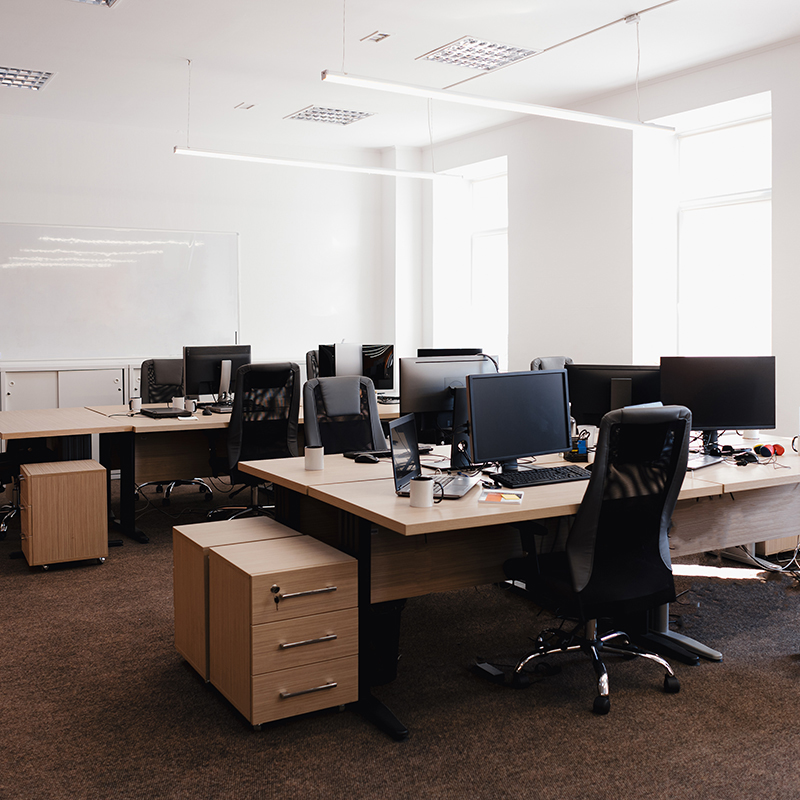 IT open space office. Computer Work Stations. Office Workplace with windows.